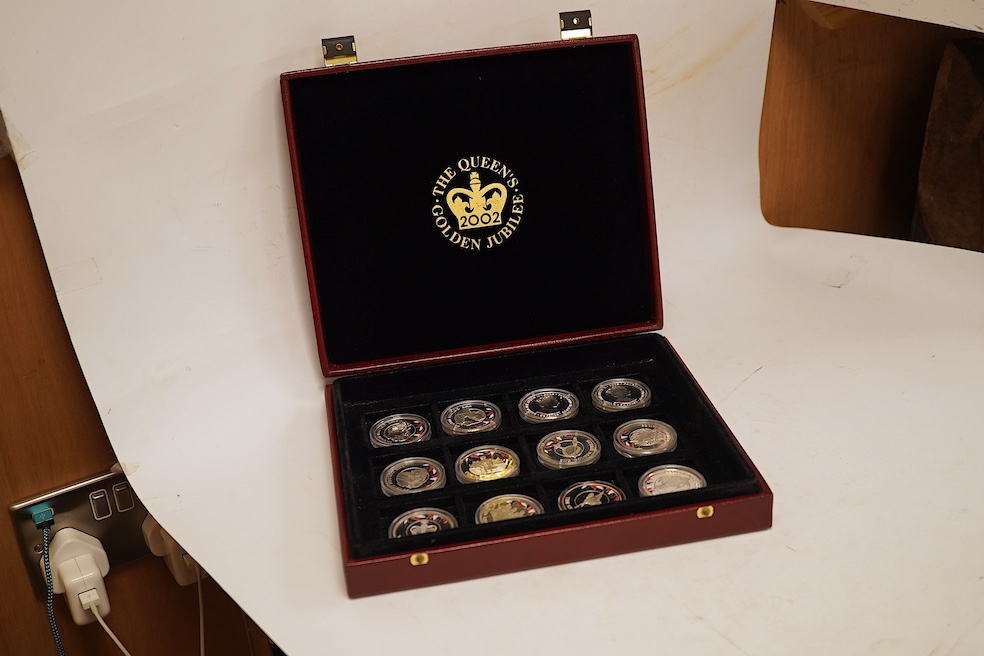 Yorkshire Mint 'Royal Arms Collection' of 12 enamelled silver armorial shields, cased and Westminster Mint 12 QEII Falkland Islands Golden Jubilee proof silver coins, cased (2 cases)